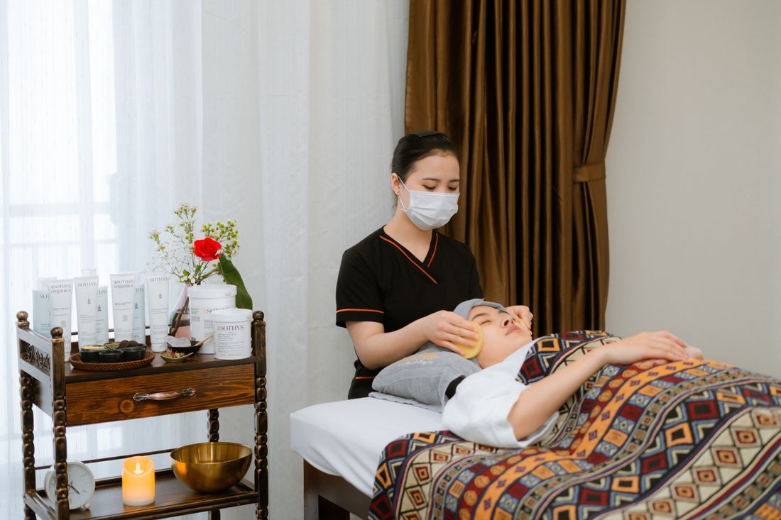 Asian spa therapist with client in a quiet wellness room