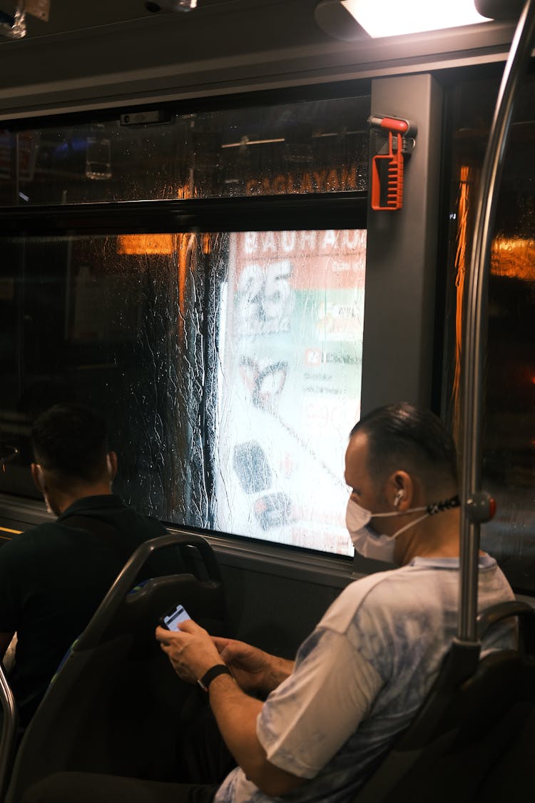 Man In Mask Sitting On Bus