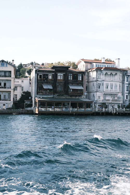 Wave near Buildings on Shore