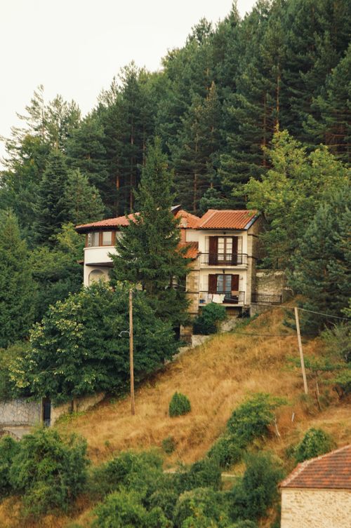Free Picturesque house nestled in the lush greenery of Kleisoura, Greece. Stock Photo