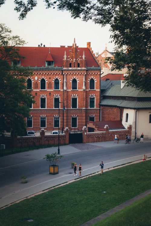 Free Charming red brick building in Krakow, Poland on a serene street view. Stock Photo