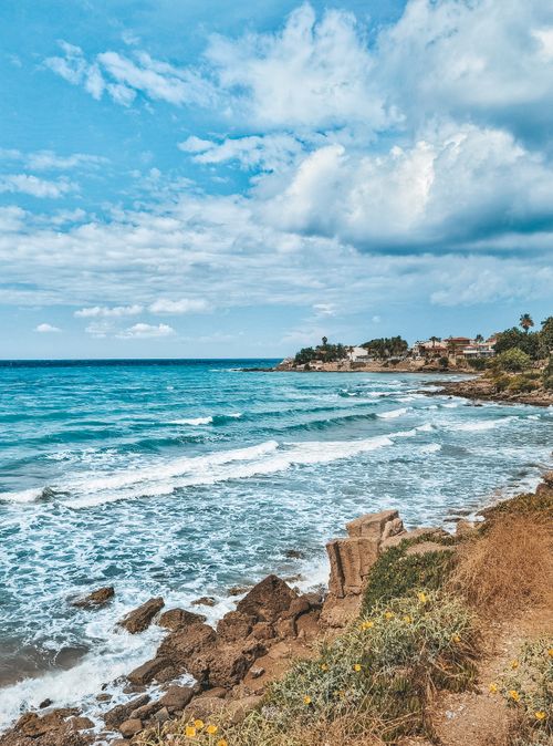 Free Explore the stunning rocky coastline of Side, Antalya, with vibrant sea and sky. Stock Photo