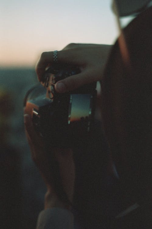 Woman Taking a Photo in the Evening