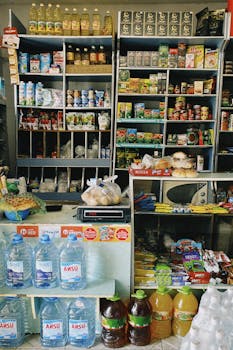 A diverse selection of products on display in a Shymkent grocery store, showcasing local and imported items.