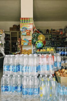 Plastic water and soda bottles in a Shymkent, Kazakhstan grocery shop's vibrant display.