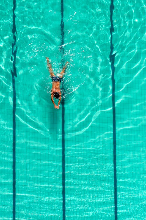 Man Swimming in a Swimming Pool