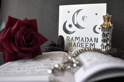 Free A stylish Ramadan Kareem greeting with a rose, prayer beads, and decorative elements, perfect for festive occasions. Stock Photo