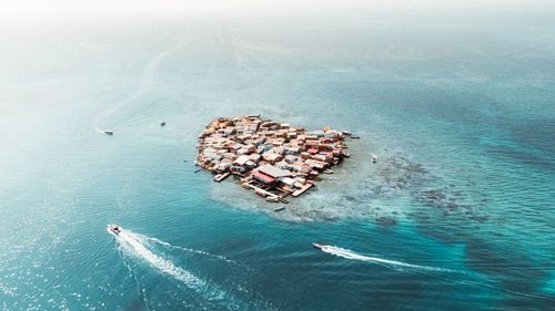 Free Stunning aerial shot of a small islet with buildings in the turquoise sea of Bolívar, Colombia. Stock Photo