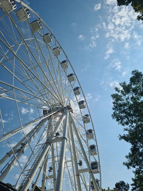Free A striking view of a Ferris wheel against a clear blue sky in Palanga, Lithuania. Stock Photo
