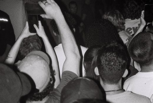 A lively crowd at a concert capturing the moment with phones in Anvers, Belgium.
