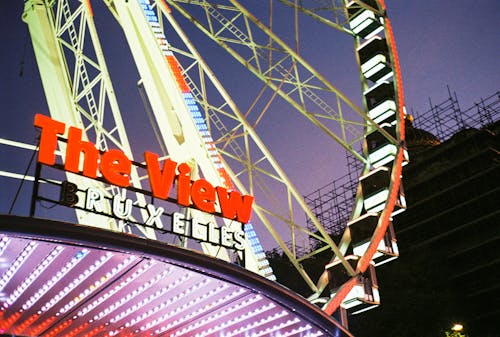 Illuminated Ferris Wheel against Night Sky