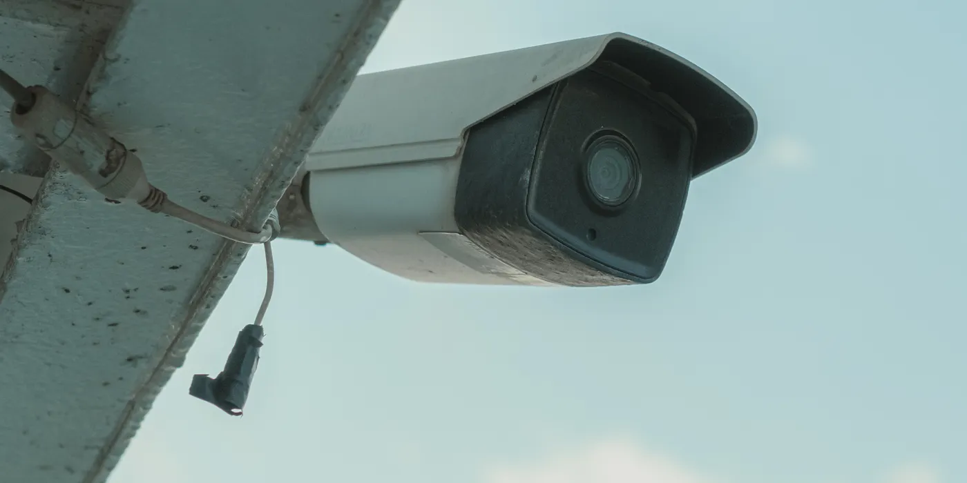 Security camera being installed on a building exterior