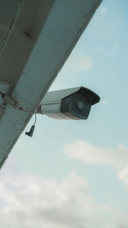 Mounted security camera on a commercial building used for live video surveillance systems