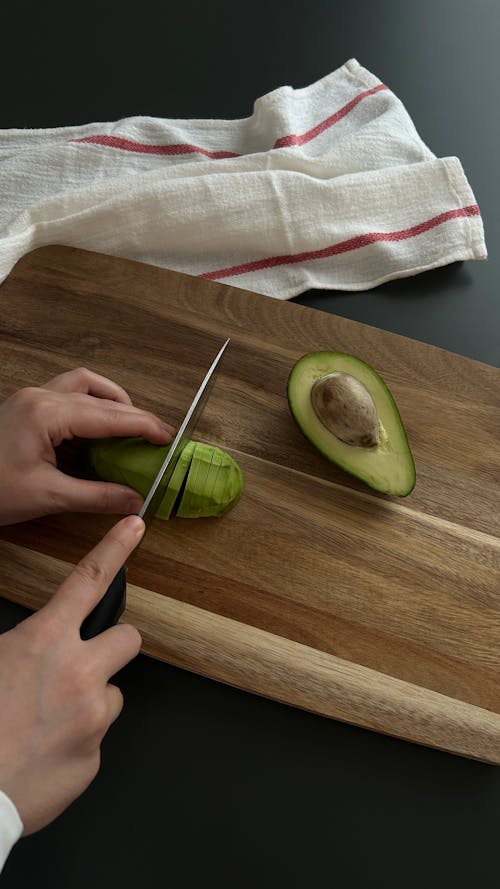 Avocado and knife on cutting board on old wooden table backgroun Photograph  by Liss Art Studio - Pixels