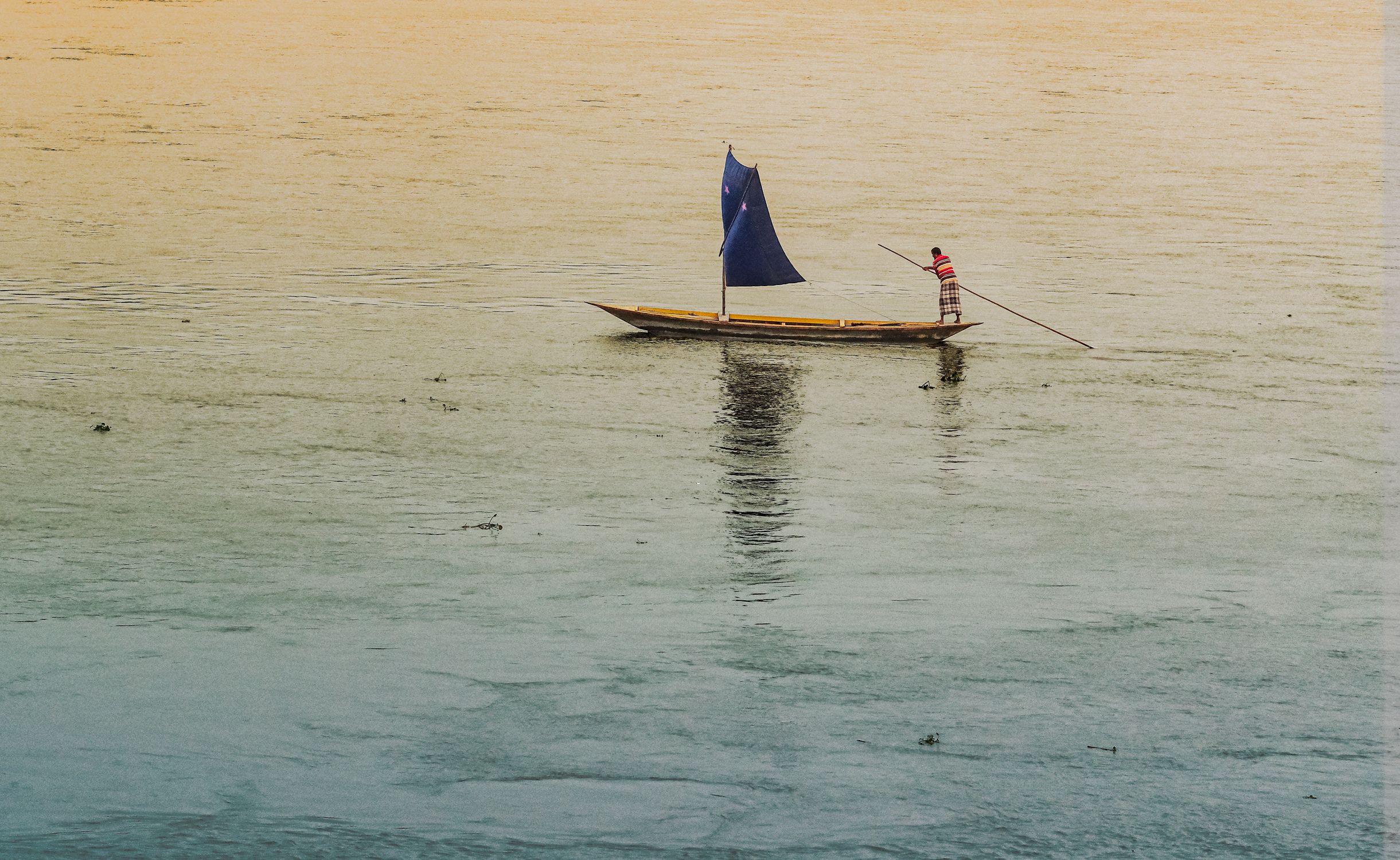 A Rowing Rod Person Rowing with Rod on Boat with Sail · Free Stock Photo