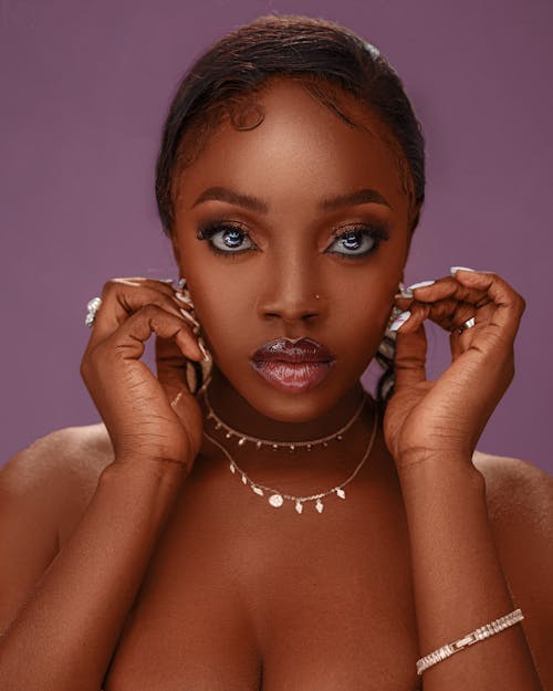 Studio Portrait of a Young Woman in Glamour Makeup and Jewelry 