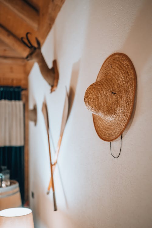 Hat Hanging on White Wall