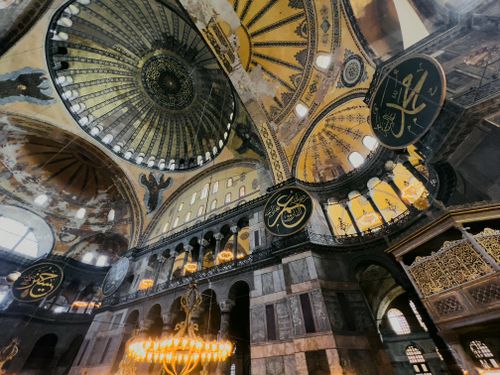 Free Explore the stunning architectural details and ornate decor of Hagia Sophia's historic dome and arches. Stock Photo