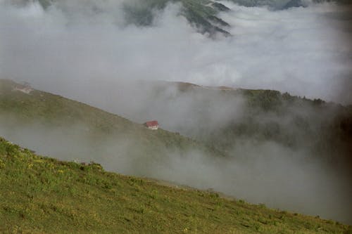 House in a Valley Covered with Fog