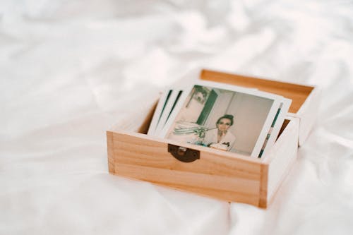 Close-Up Of Pictures On Wooden Box