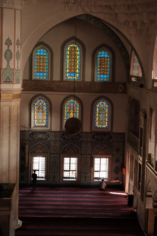 Free Beautifully decorated mosque interior with stained glass windows and intricate tile details, showcasing Islamic art. Stock Photo