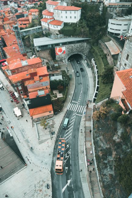 Drone shot capturing cityscape with urban roads and vibrant architecture.