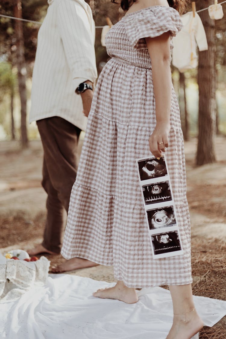 A Woman Holding Ultrasound Baby Pictures 