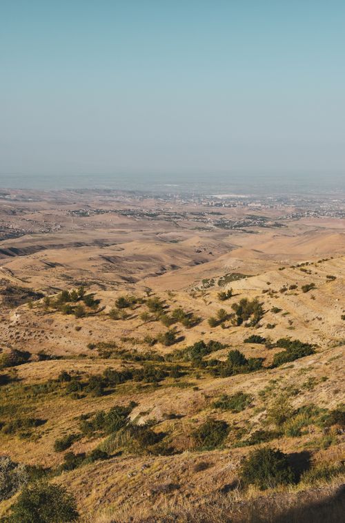 Free A stunning view of arid rolling hills under a clear blue sky, showcasing nature's beauty. Stock Photo