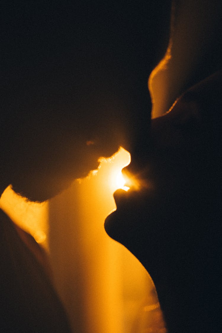 Sunlight Over Faces Of Kissing Woman And Man