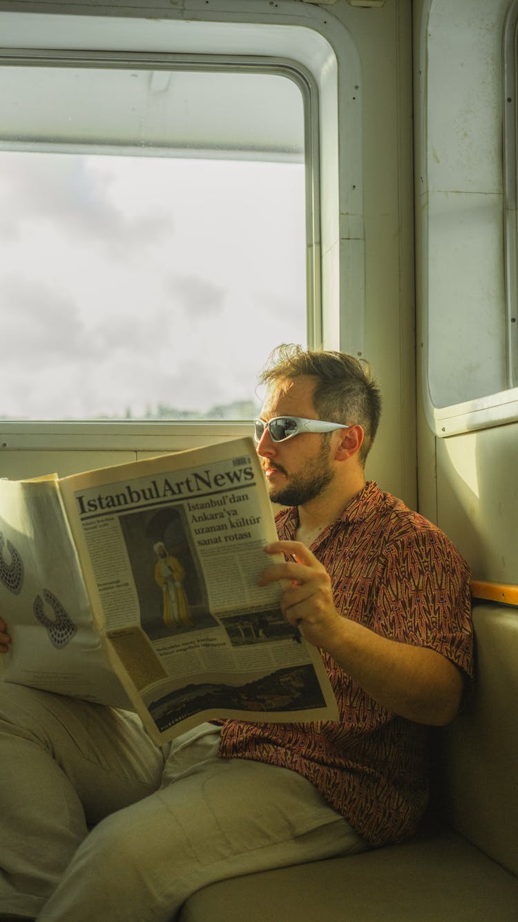 Passenger Of Ferry Reading Newspaper