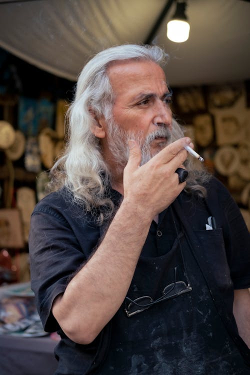 Portrait of a Long-Haired Senior Smoking a Cigarette