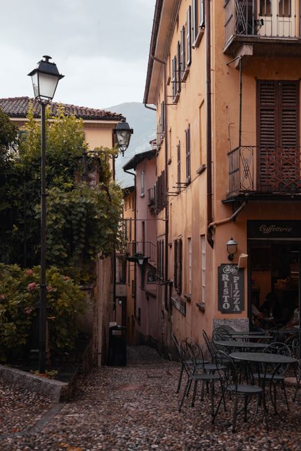 Narrow, picturesque alleyway with cobblestone streets and historic buildings in a quaint town setting.