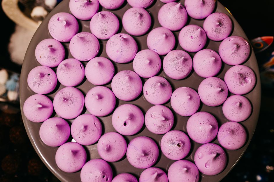 A tray filled with pink meringue cookies, perfect for sweet indulgence and dessert photography.