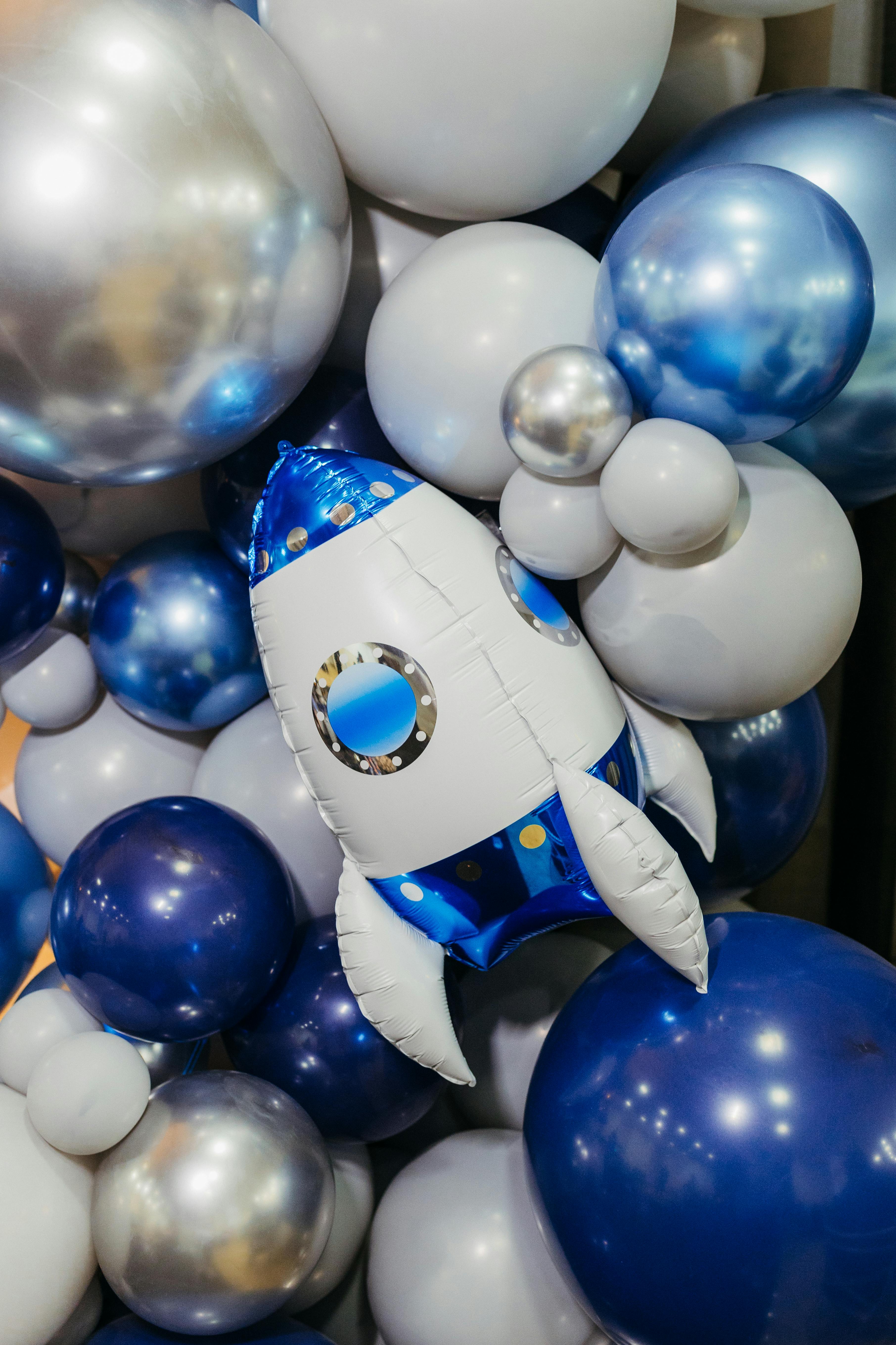 Festive blue and white balloon display featuring an inflatable rocket.