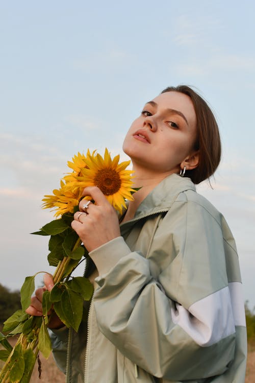 Young Woman in Tracksuit Posing with Flowers