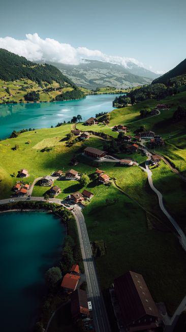 Breathtaking aerial shot of Lungern Lake and village in Switzerland surrounded by lush mountains.