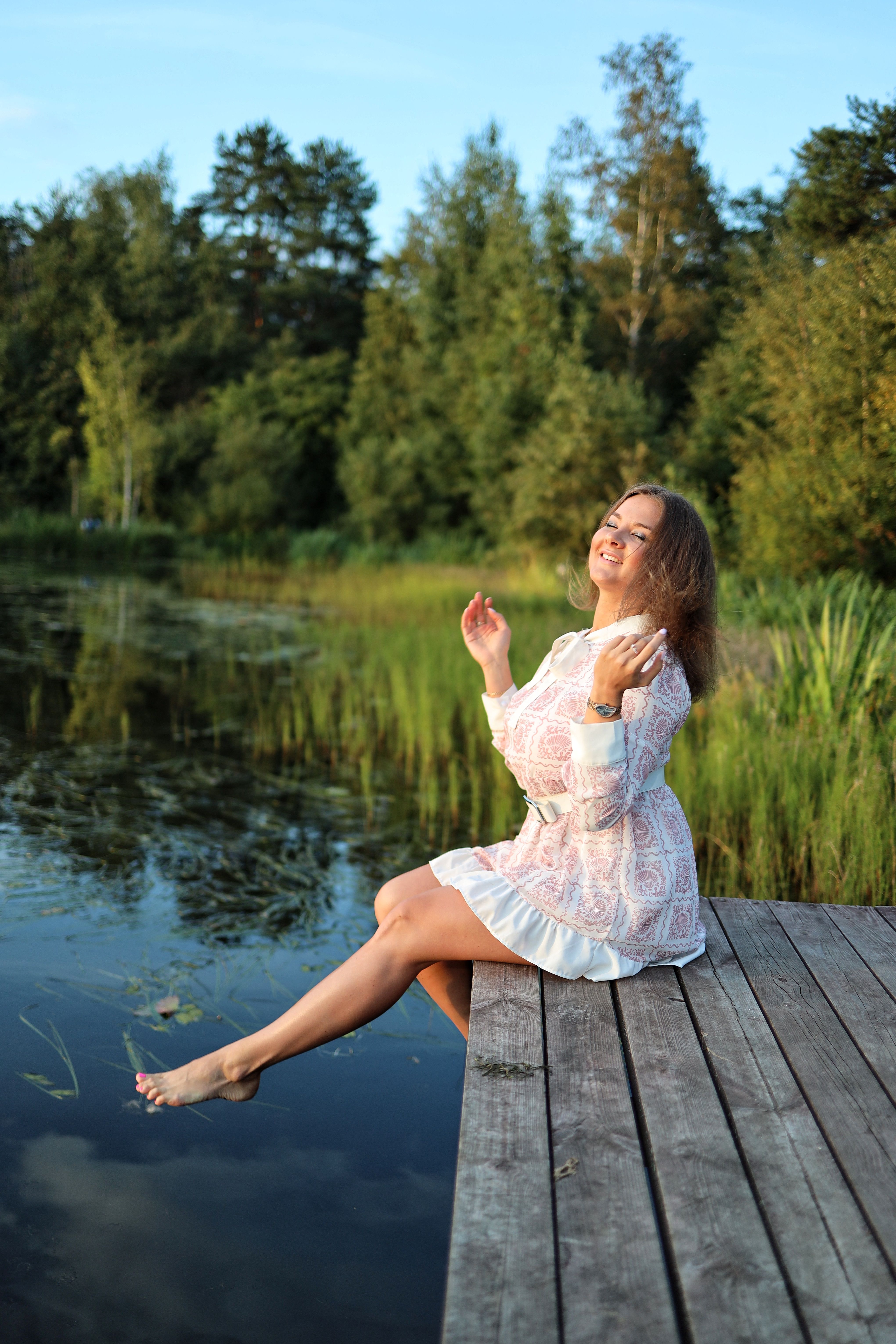 A Woman Sitting on a Wooden Pier · Free Stock Photo