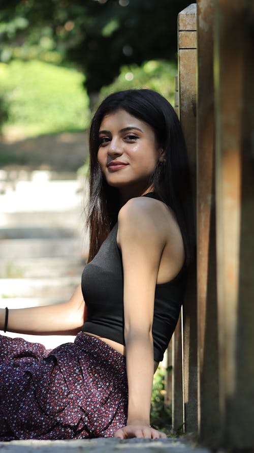 Beautiful Young Woman Sitting and Smiling