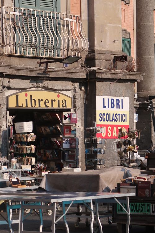 Free Historic bookstore facade with outdoor book display under sunlight. Stock Photo