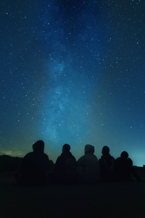 People Sitting and Watching the Night Sky 