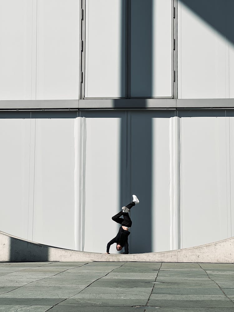 Person Standing On Their Hands By A Modern Building