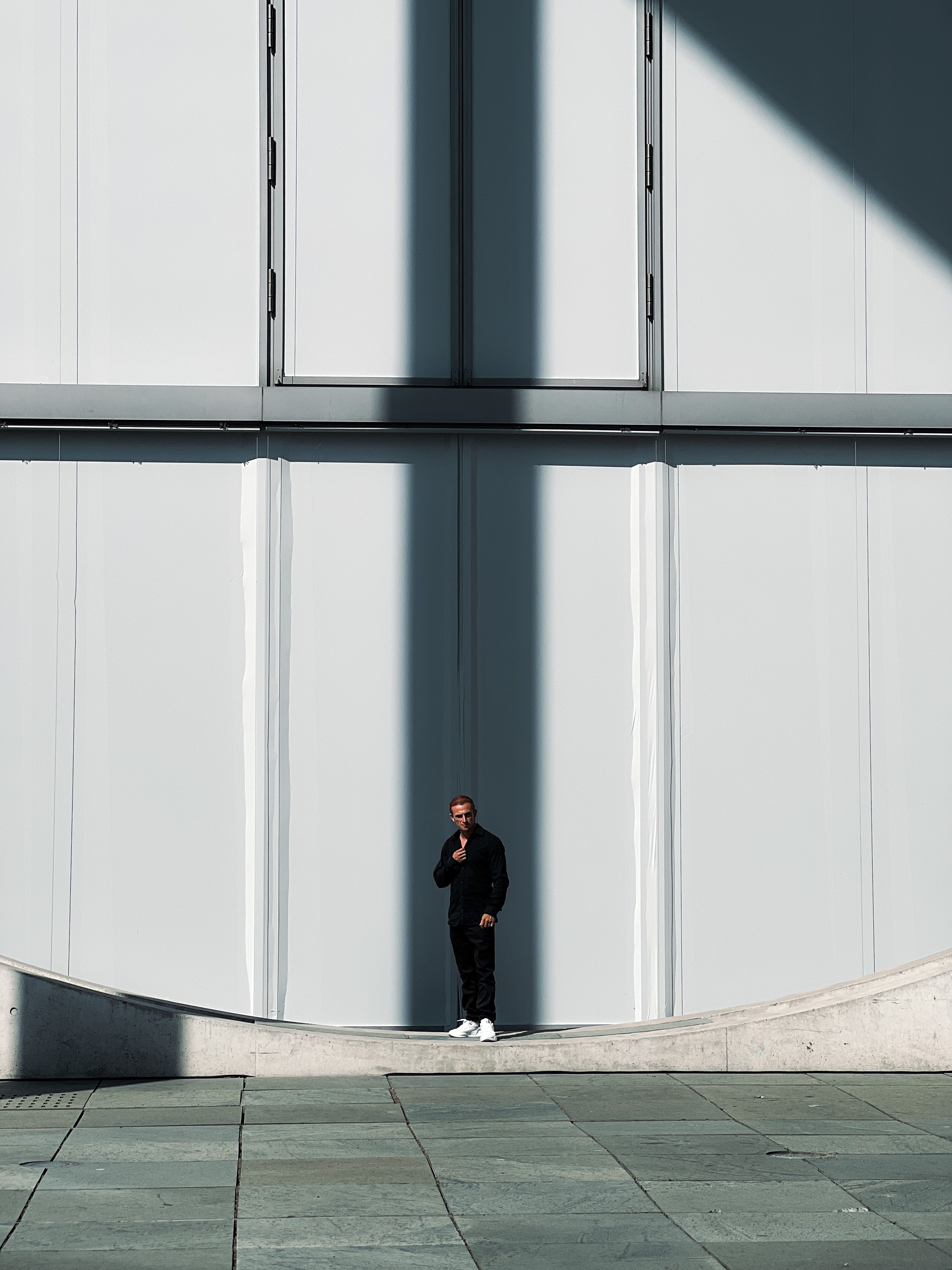 A Man Standing in front of a Modern Building · Free Stock Photo