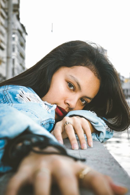 Photo D'une Femme En Veste En Jean Bleu S'appuyant Sur Une Balustrade En Pierre