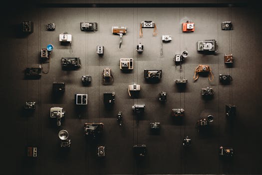 A wall adorned with an impressive collection of vintage cameras, showcasing rich photography history.