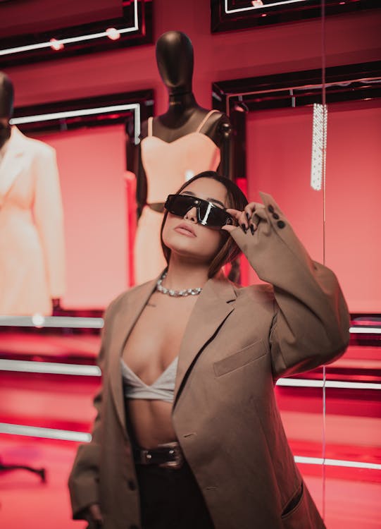 Young Fashionable Woman in Sunglasses Posing in City at Night 