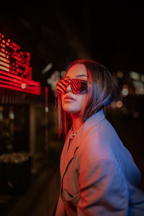 Red Light over Woman in Sunglasses at Night