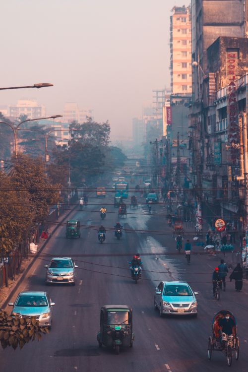 Free A bustling urban street in an Asian city with traffic and pedestrians. Stock Photo