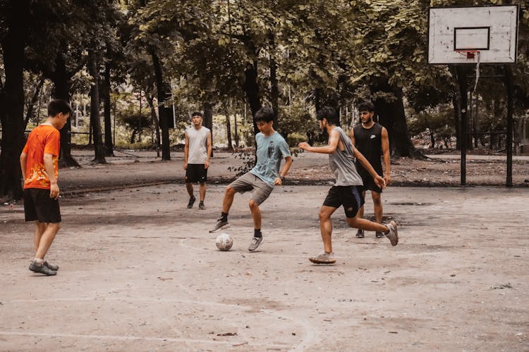 Boys Playing Soccer In Park