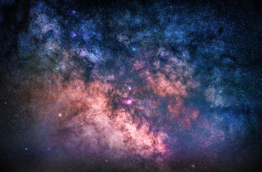 Colorful depiction of the Milky Way galaxy with vivid stars and nebulae visible from Earth.
