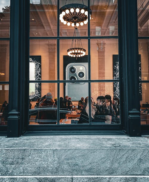 People Sitting behind Restaurant Windows